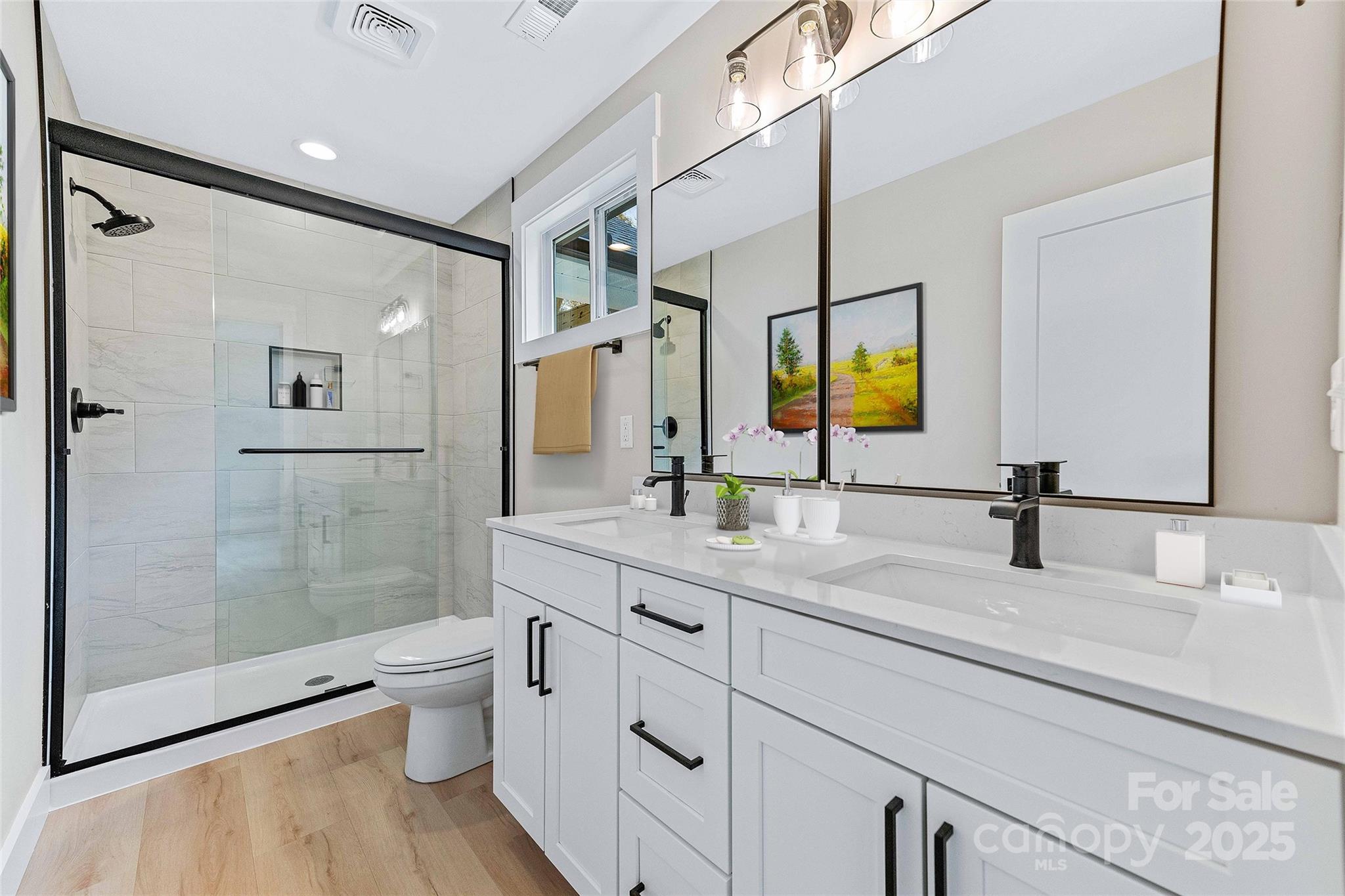 775 Olivette Road Asheville, NC 28804 - Photo 32 of 45 a bathroom with a double vanity sink toilet and shower