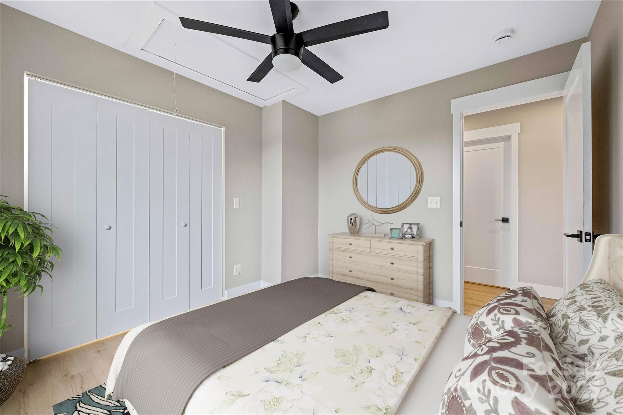 775 Olivette Road Asheville, NC 28804 - Photo 36 of 45 a bedroom with a bed and a potted plant