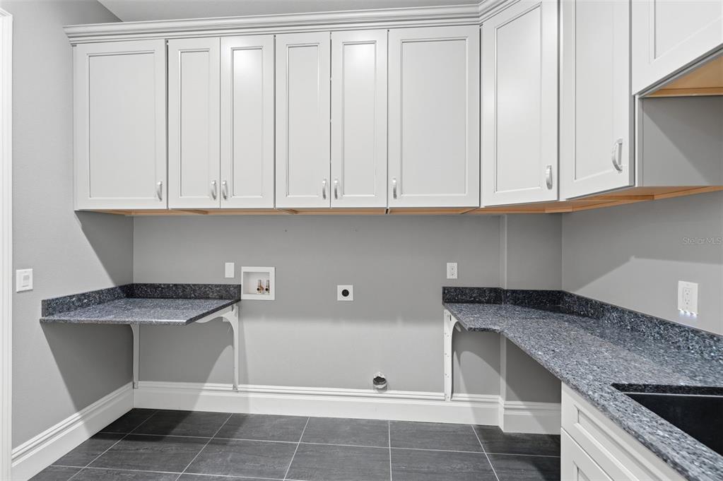 855 Southeast 87th Street Ocala, FL 34480 - Photo 48 of 79 a kitchen with granite countertop a white cabinets and a sink