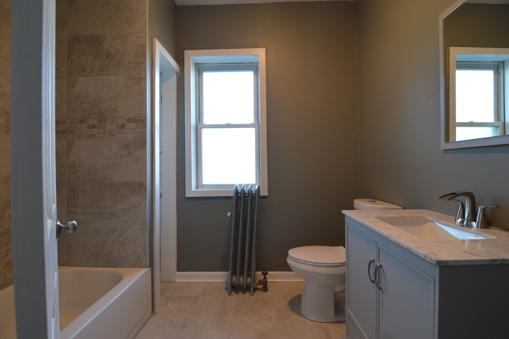 3422 West Grenshaw Street, Unit 2 Chicago, IL 60624 - Photo 7 of 12 a bathroom with a toilet sink and a bathtub