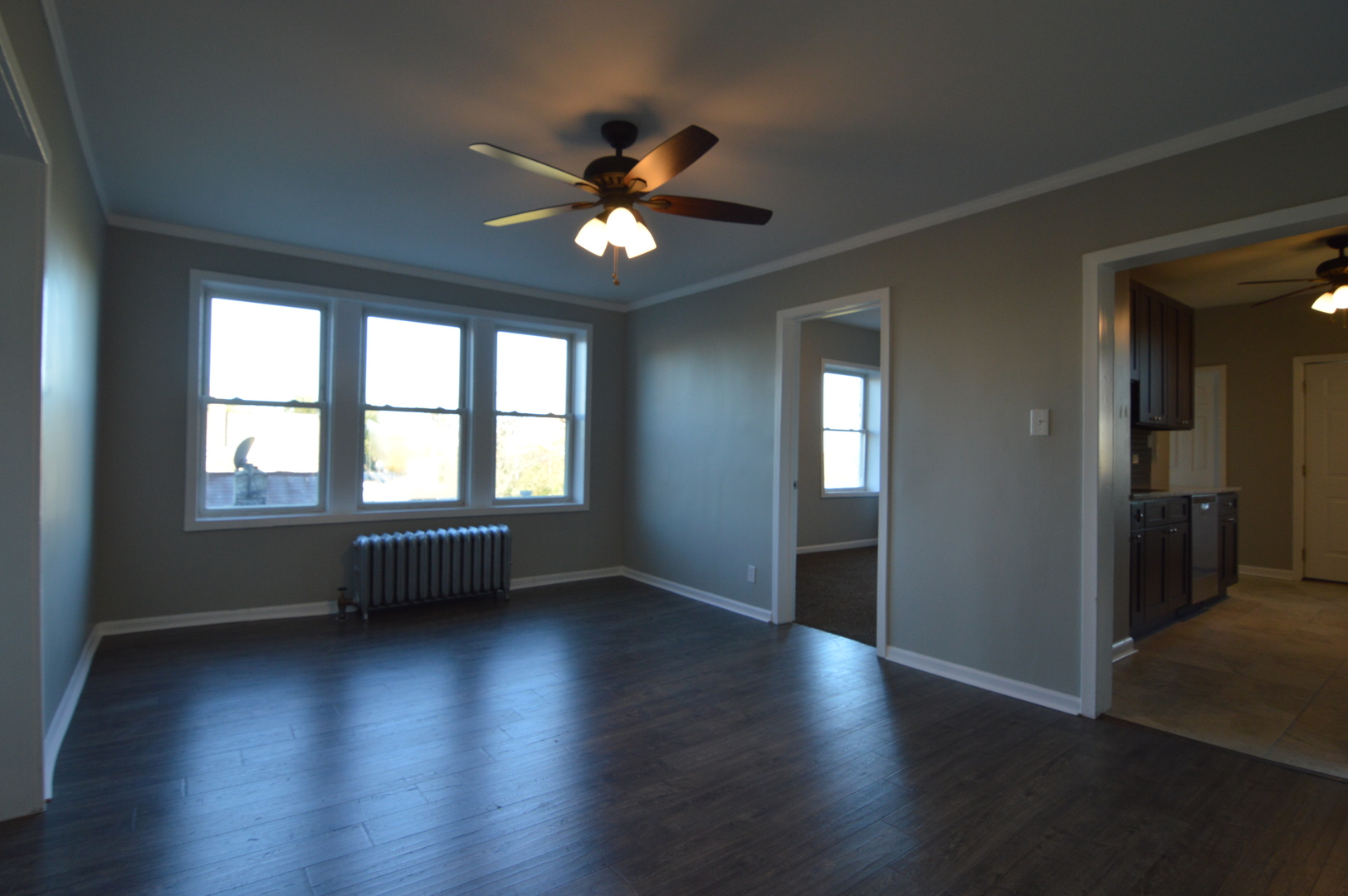 3422 West Grenshaw Street, Unit 2 Chicago, IL 60624 - Photo 8 of 12 an empty room with wooden floor fan and windows