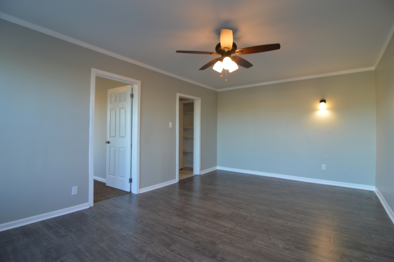 3422 West Grenshaw Street, Unit 2 Chicago, IL 60624 - Photo 9 of 12 an empty room with wooden floor fan and windows