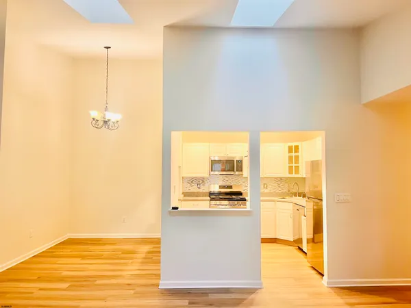 a view of a kitchen with wooden floor