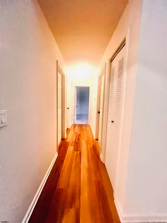 a view of a bathroom with sink and wooden floor