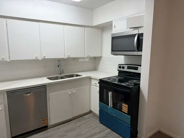 a kitchen with a stove and a microwave