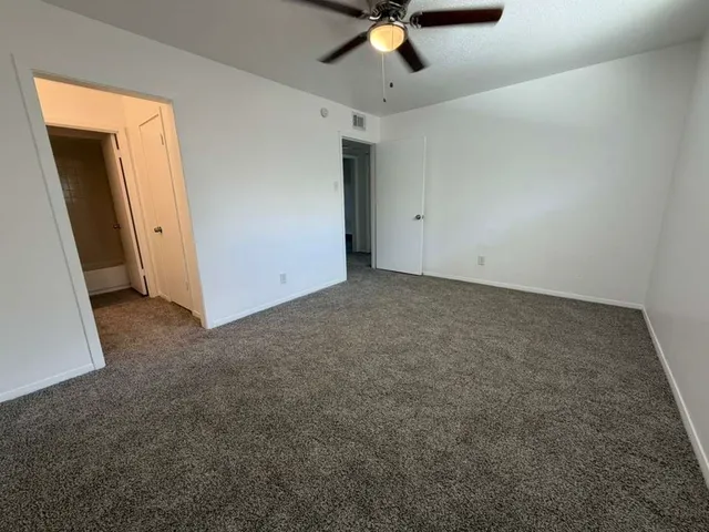 an empty room with a ceiling fan