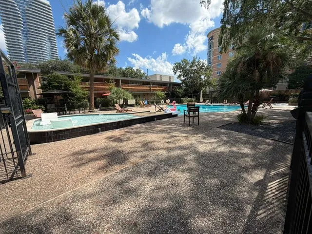 a view of a patio with a table and chairs under an umbrella