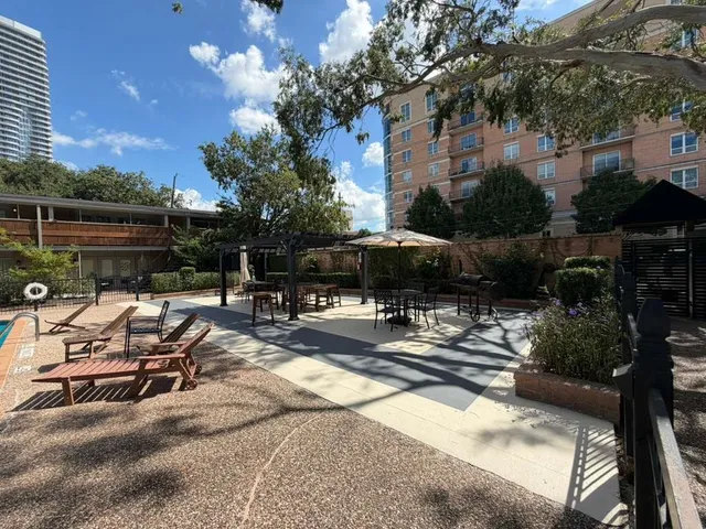 a view of backyard with swimming pool and furniture