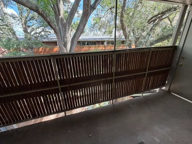 a view of balcony with wooden floor and fence