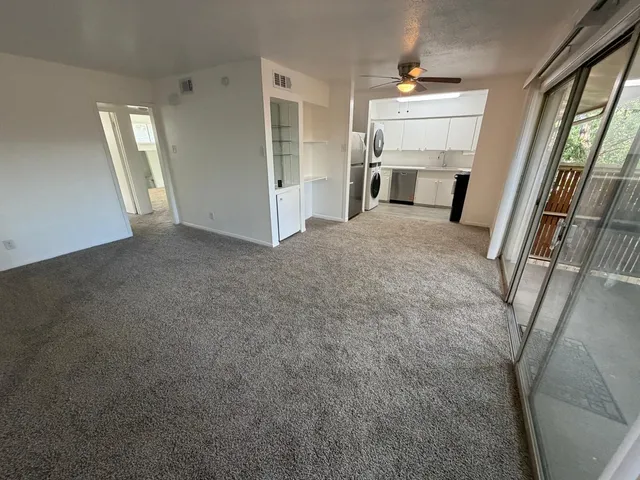 a view of a livingroom with furniture and staircase