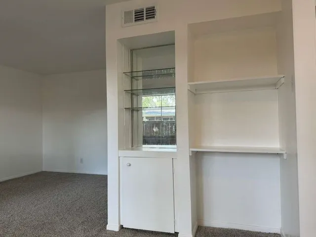 a view of an empty room with closet