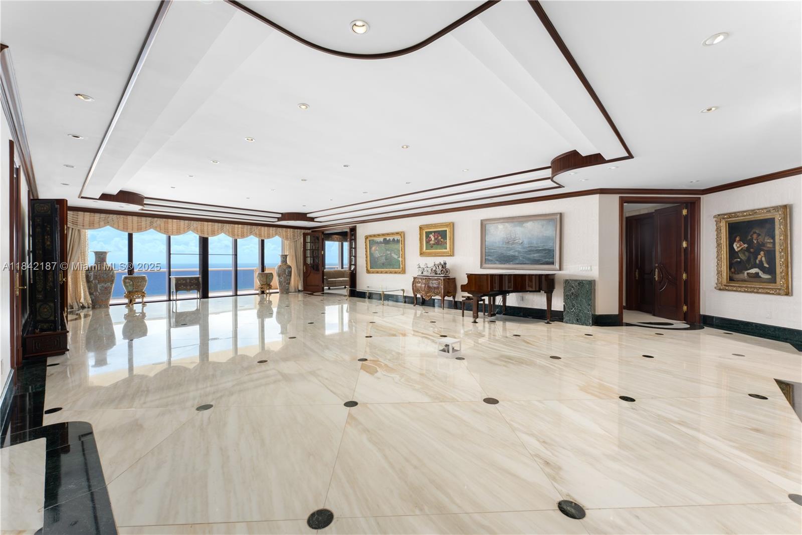 5757 Collins Avenue, Unit PH4 Miami Beach, FL 33140 - Photo 11 of 27 a view of a hallway with wooden floor and furniture