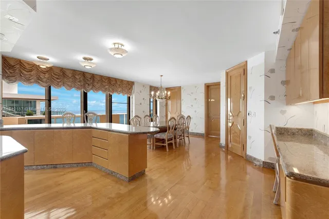 a large kitchen with kitchen island a sink stainless steel appliances and cabinets