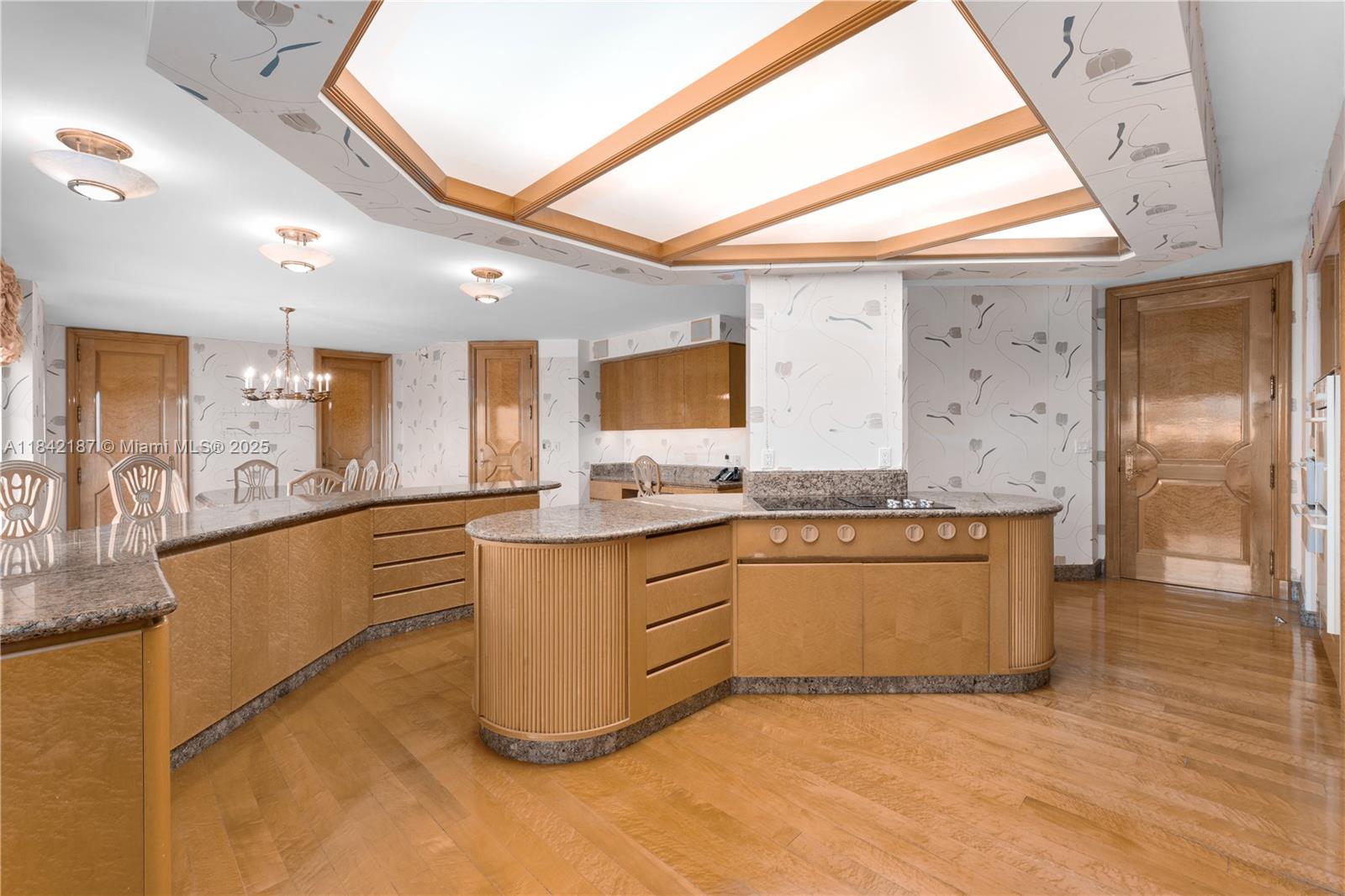 5757 Collins Avenue, Unit PH4 Miami Beach, FL 33140 - Photo 17 of 27 a large kitchen with kitchen island a sink stainless steel appliances and cabinets