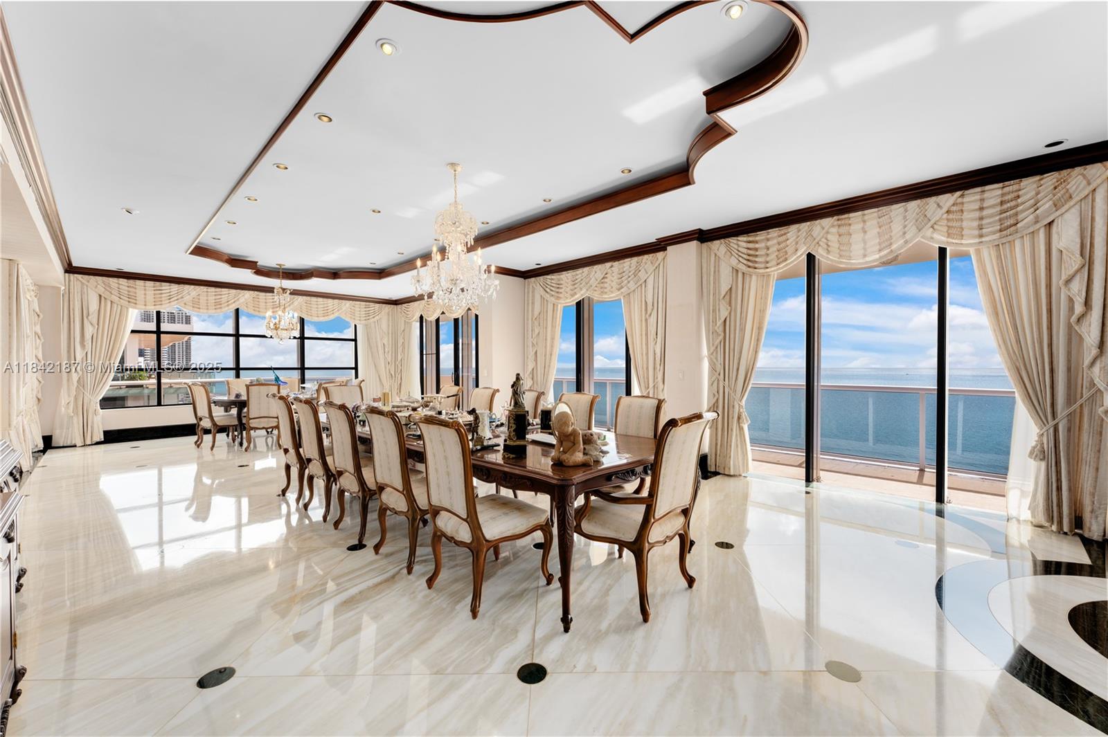 5757 Collins Avenue, Unit PH4 Miami Beach, FL 33140 - Photo 2 of 27 a dining room with furniture and floor to ceiling window