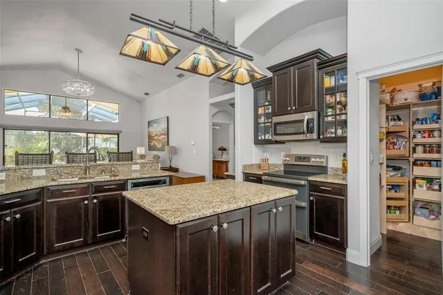 a kitchen with stainless steel appliances granite countertop a stove and a refrigerator