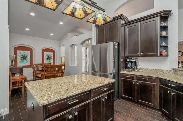 a living room with furniture a rug wooden floor and a large window