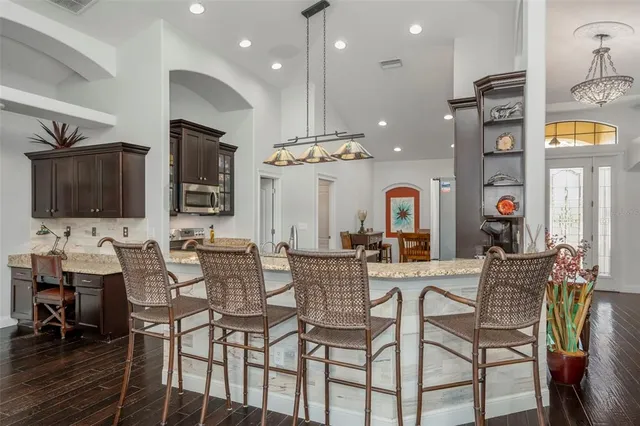 a living room with furniture a flat screen tv and large window