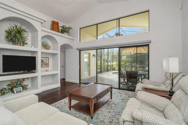 a bedroom with a bed and flat tv screen on the dresser