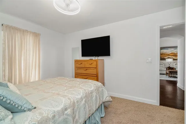 a bed room with a bed and a chair