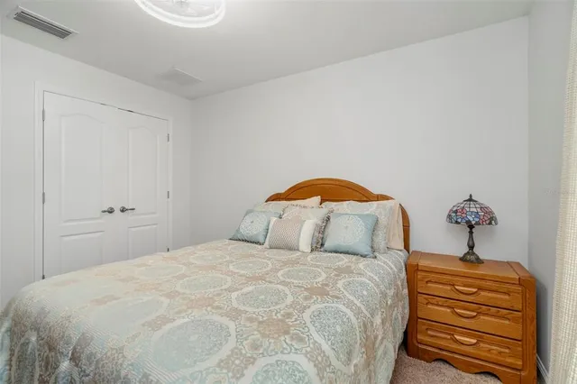 a bedroom with bed and flat screen tv