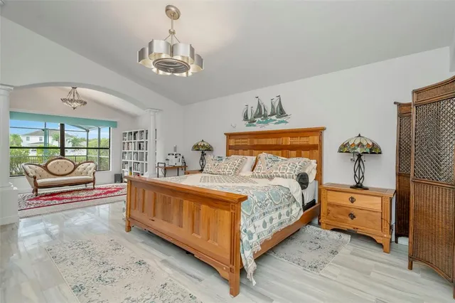 a bedroom with a bed and a flat tv screen on dresser