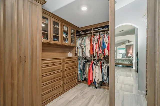 a view of an empty room and kitchen view