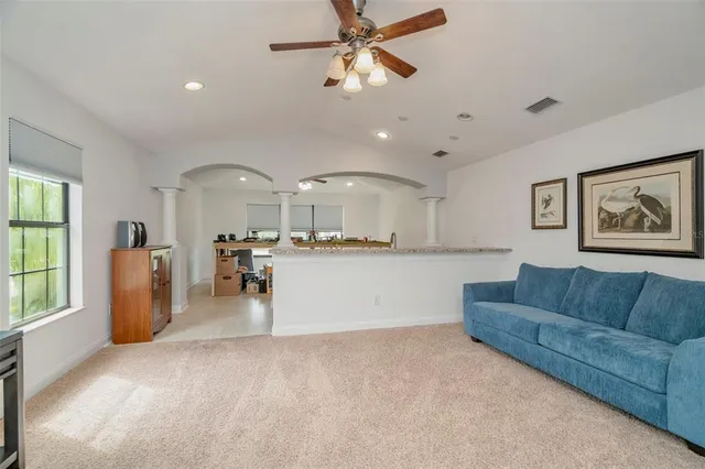 a view of a backyard with table and chairs under an umbrella