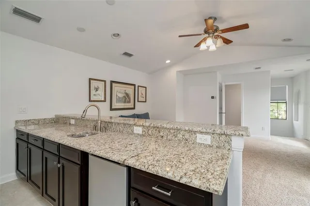 a view of a house with a yard and potted plants