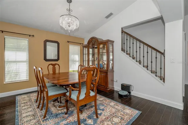 a view of a dining room with furniture and wooden floor