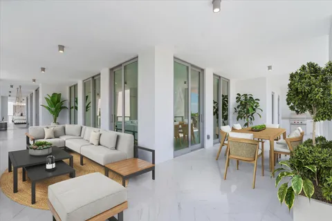 a living room with stainless steel appliances kitchen island granite countertop a dining table chairs and a large window