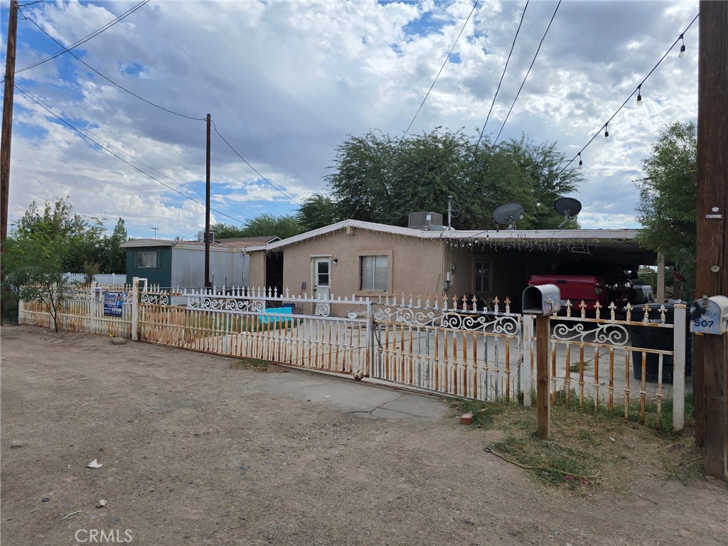 a view of a house with wooden fence