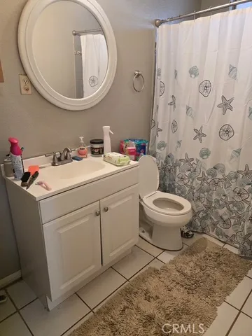 a bathroom with a sink toilet and a mirror