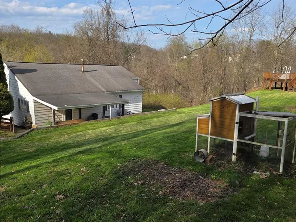 a view of a house with a backyard