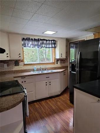 a kitchen with a sink window and cabinets