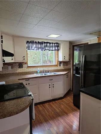 a kitchen with a stove a sink and a refrigerator