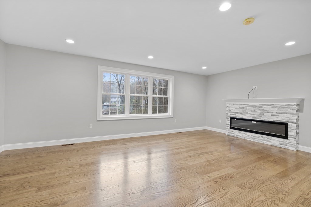 48 Aldrich Road Wilmington, MA 01887 - Photo 14 of 42 a view of an empty room with a fireplace and a window