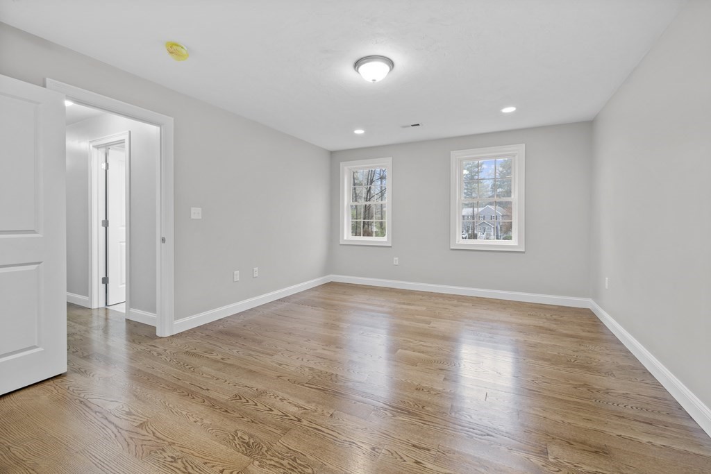48 Aldrich Road Wilmington, MA 01887 - Photo 23 of 42 an empty room with wooden floor and windows