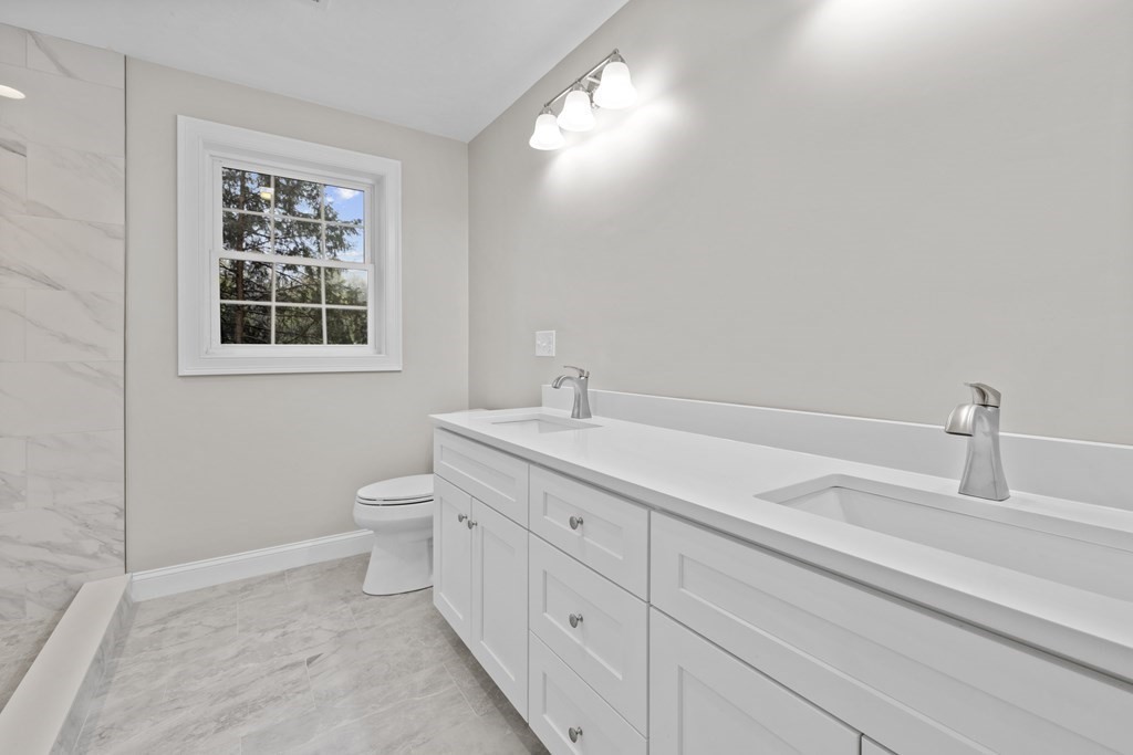 48 Aldrich Road Wilmington, MA 01887 - Photo 24 of 42 a bathroom with a toilet sink and mirror