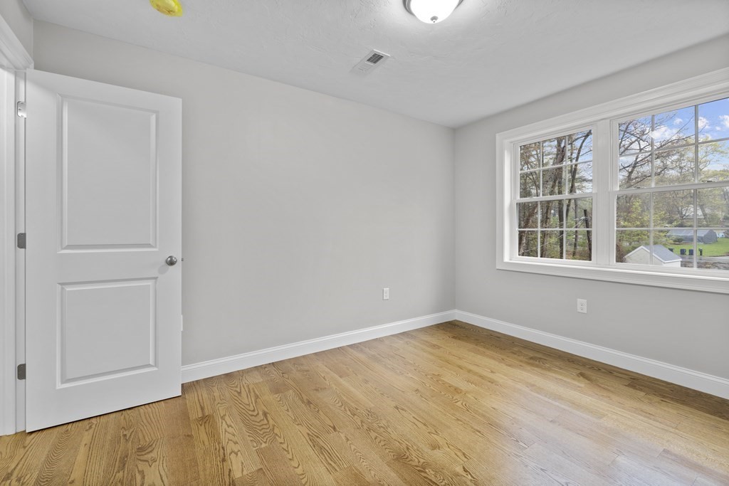 48 Aldrich Road Wilmington, MA 01887 - Photo 26 of 42 a view of empty room with wooden floor and fan