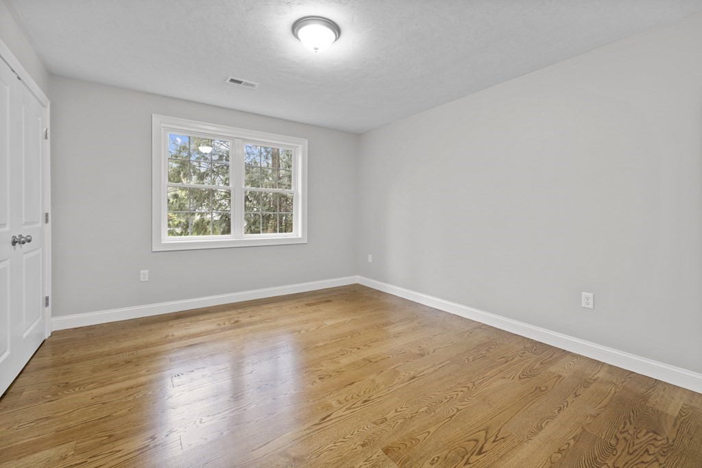 48 Aldrich Road Wilmington, MA 01887 - Photo 27 of 42 an empty room with wooden floor and windows