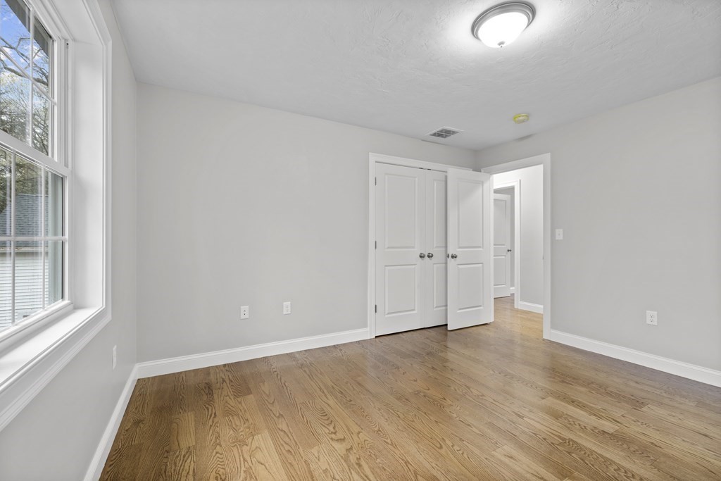 48 Aldrich Road Wilmington, MA 01887 - Photo 32 of 42 an empty room with wooden floor and windows