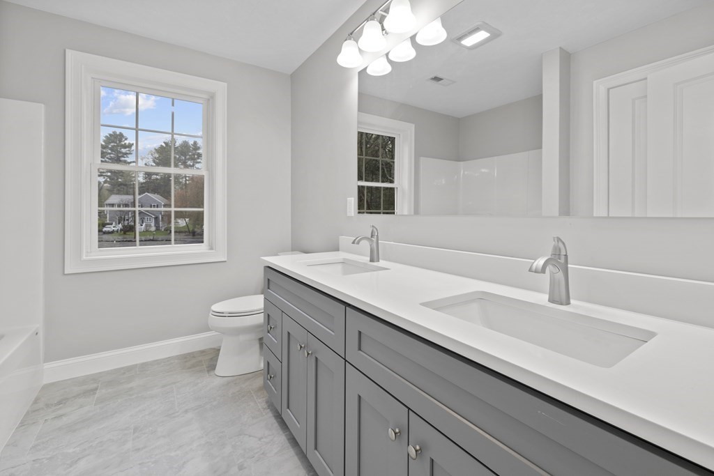 48 Aldrich Road Wilmington, MA 01887 - Photo 34 of 42 a bathroom with a sink a large mirror and a toilet