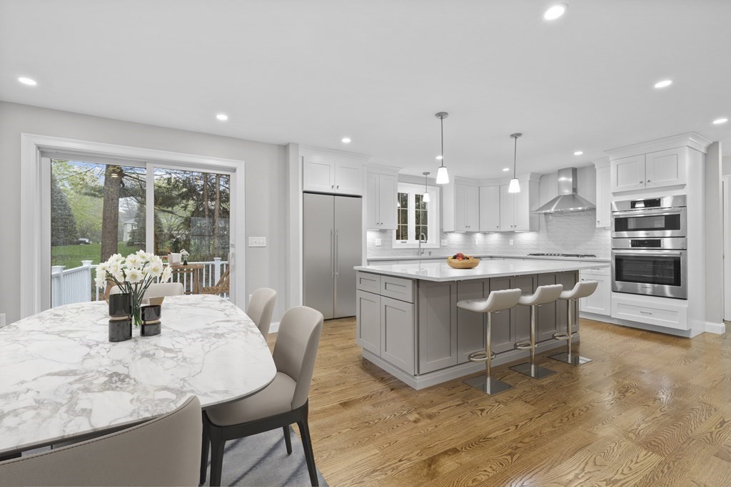 48 Aldrich Road Wilmington, MA 01887 - Photo 4 of 42 a kitchen with stainless steel appliances kitchen island granite countertop a table chairs and a refrigerator