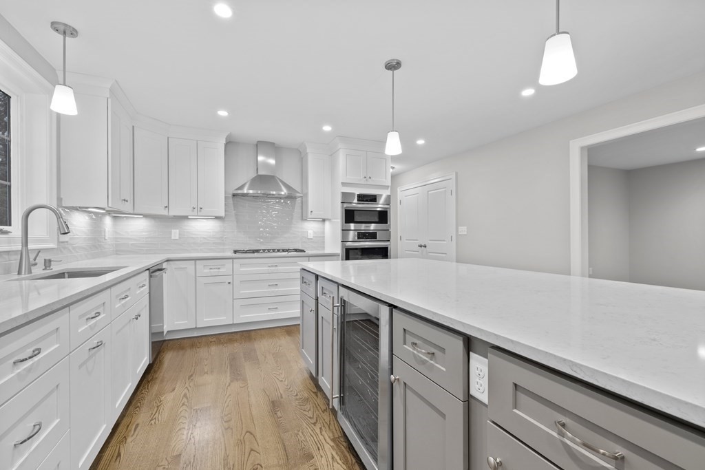 48 Aldrich Road Wilmington, MA 01887 - Photo 7 of 42 a kitchen with a sink stainless steel appliances and white cabinets