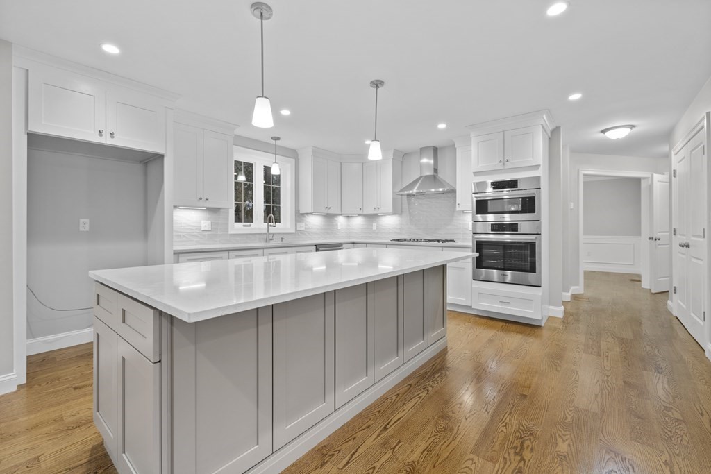 48 Aldrich Road Wilmington, MA 01887 - Photo 8 of 42 a kitchen with kitchen island a sink and a stove top oven