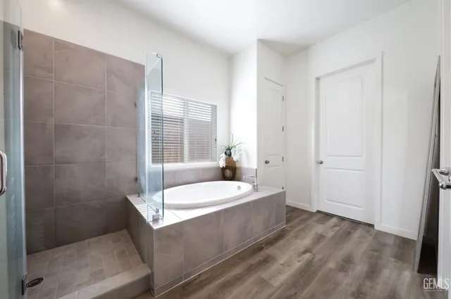 a spacious bathroom with a tub shower and sink