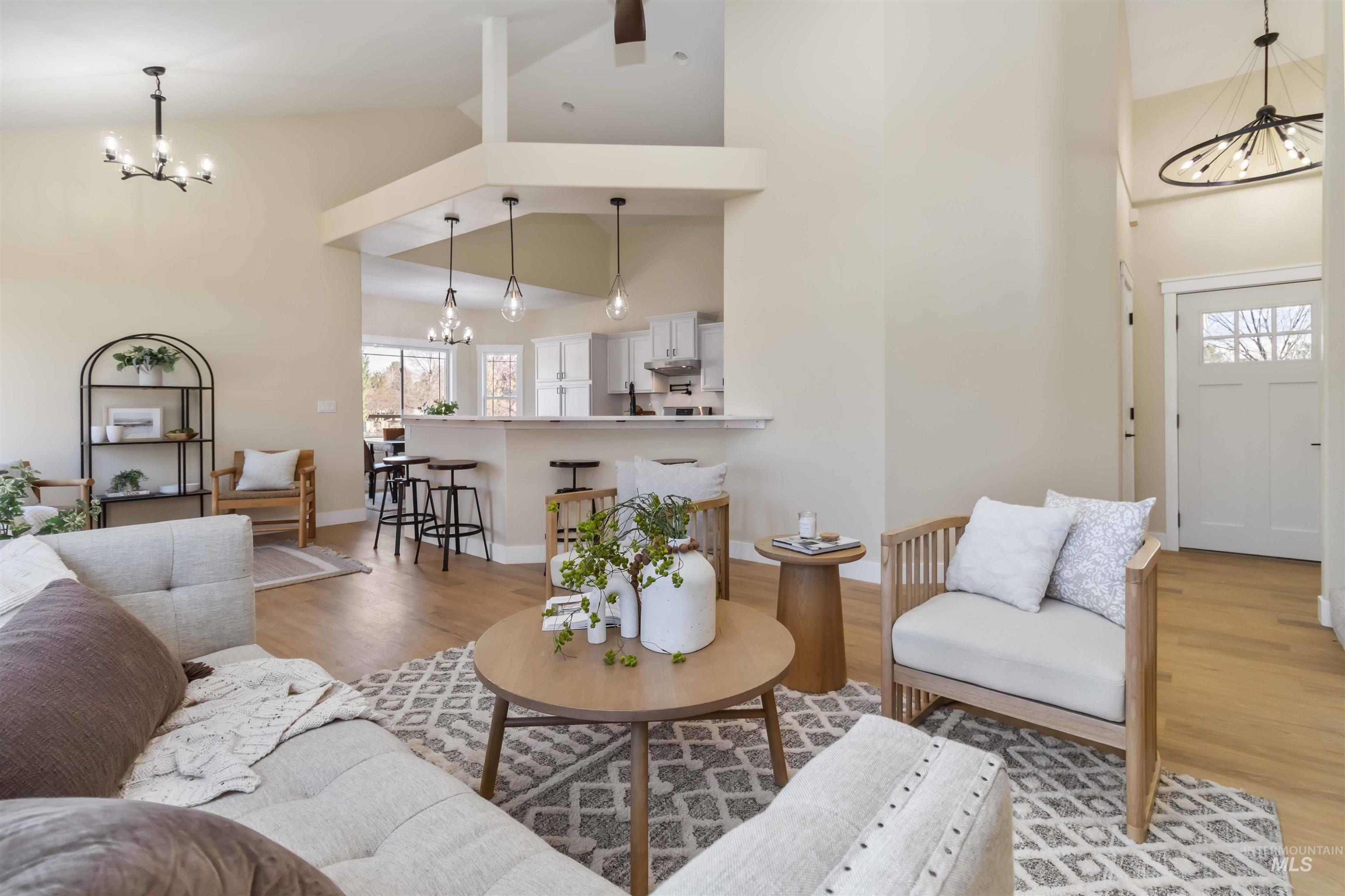 3201 Raintree Drive Nampa, ID 83686 - Photo 12 of 50 Living area with a chandelier, high vaulted ceiling, and light wood-style flooring