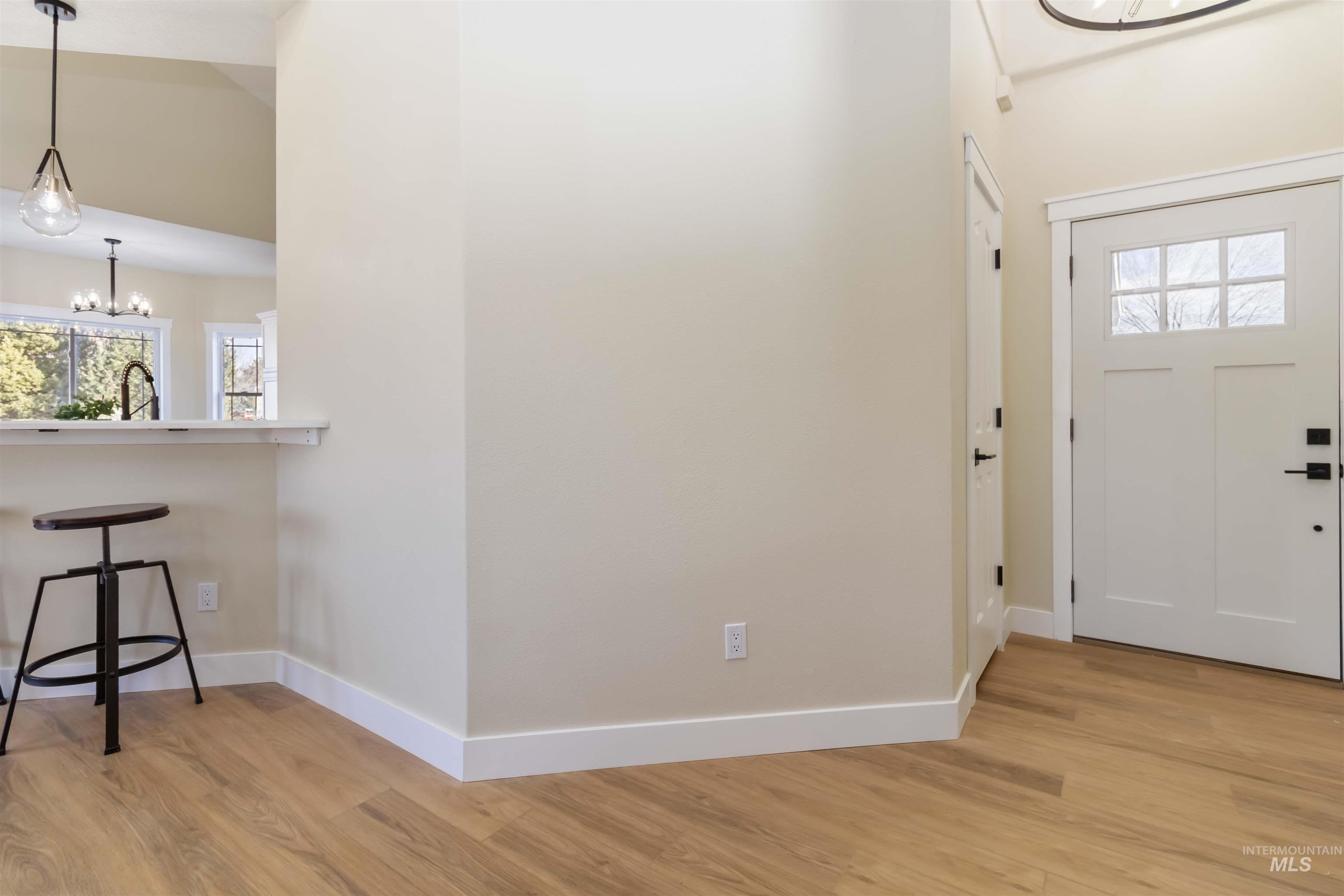 3201 Raintree Drive Nampa, ID 83686 - Photo 14 of 50 Foyer entrance with plenty of natural light, light wood-type flooring, and a chandelier