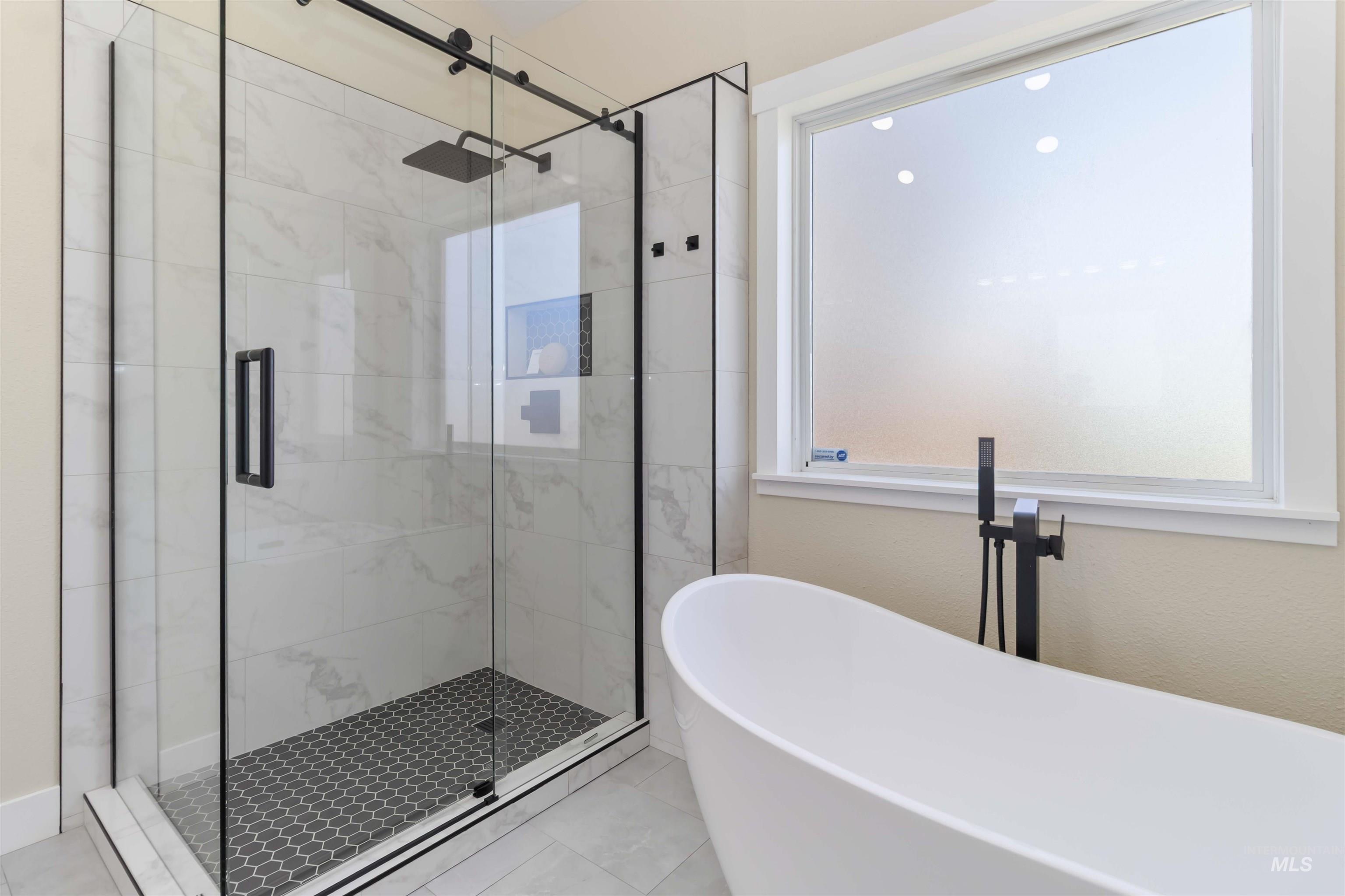 3201 Raintree Drive Nampa, ID 83686 - Photo 20 of 50 Full bath with a freestanding bath, a stall shower, and tile patterned floors